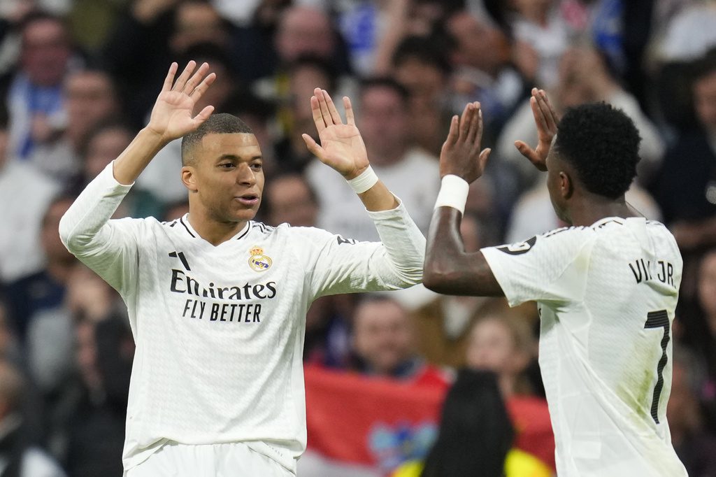 Real Madrid's Vinicius Junior, right, celebrates with Kylian Mbappe after scoring his side's second goal during the Spanish La Liga soccer match between Real Madrid and Girona at the Santiago Bernabeu stadium in Madrid, Spain, Sunday, Feb. 23, 2025. -- AP Photo