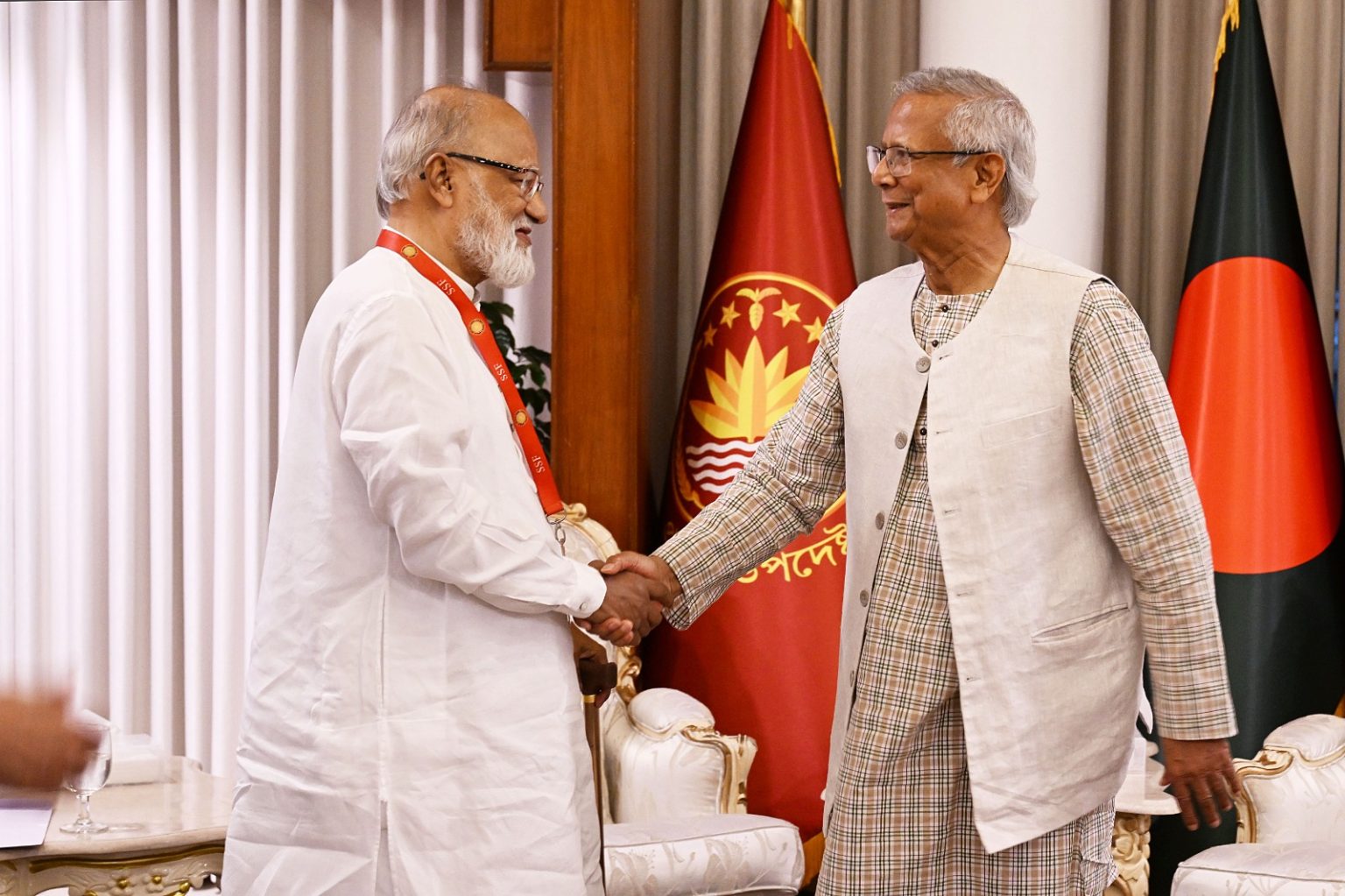 Chief Adviser Muhammad Yunus shakes habd with BNP standing committee member Khandaker Mosharraf Hossain at the beginning of a political dialogue at the CA's official residence in Dhaka. Photo: Chief Adviser's press wing