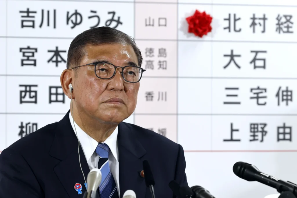 Japan’s PM vows to stay on despite bruising election loss