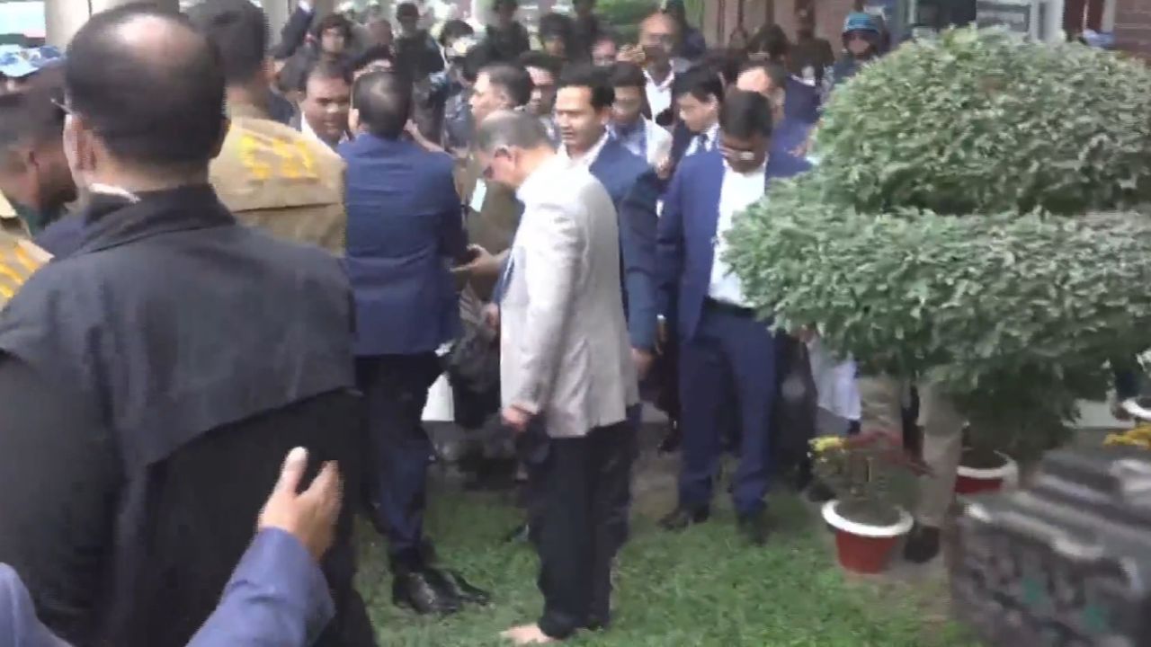 Tarique stands barefoot on homeland soil